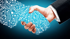 Digital handshake on blue background