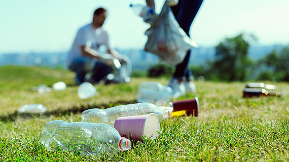 Close up of plastic bottles that lying on the grass