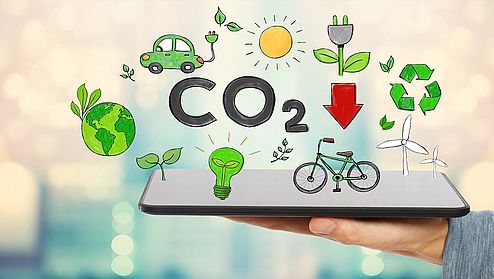 Reduce CO2 with man holding a tablet