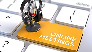 Online meetings, Online Education and Training concept - Orange Online meetings button with microphone and headphones. 3d rendering