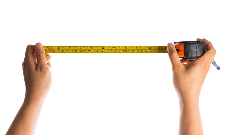 hand holding tape measure