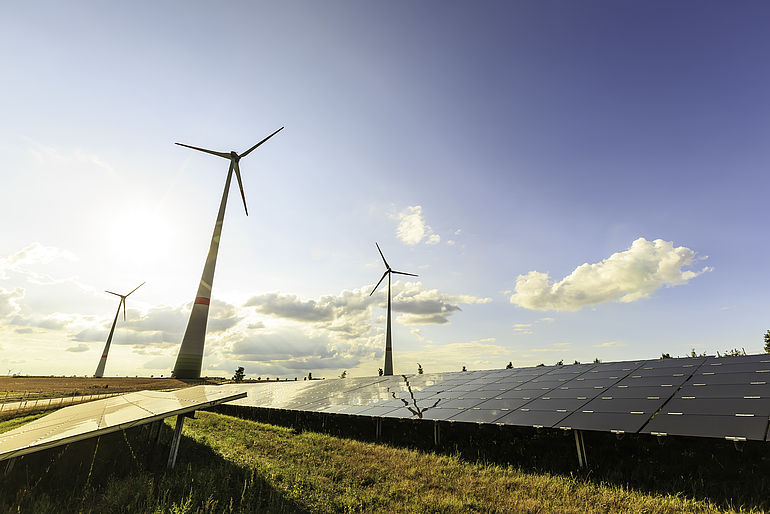 wind turbines and modern solar panels in the country side