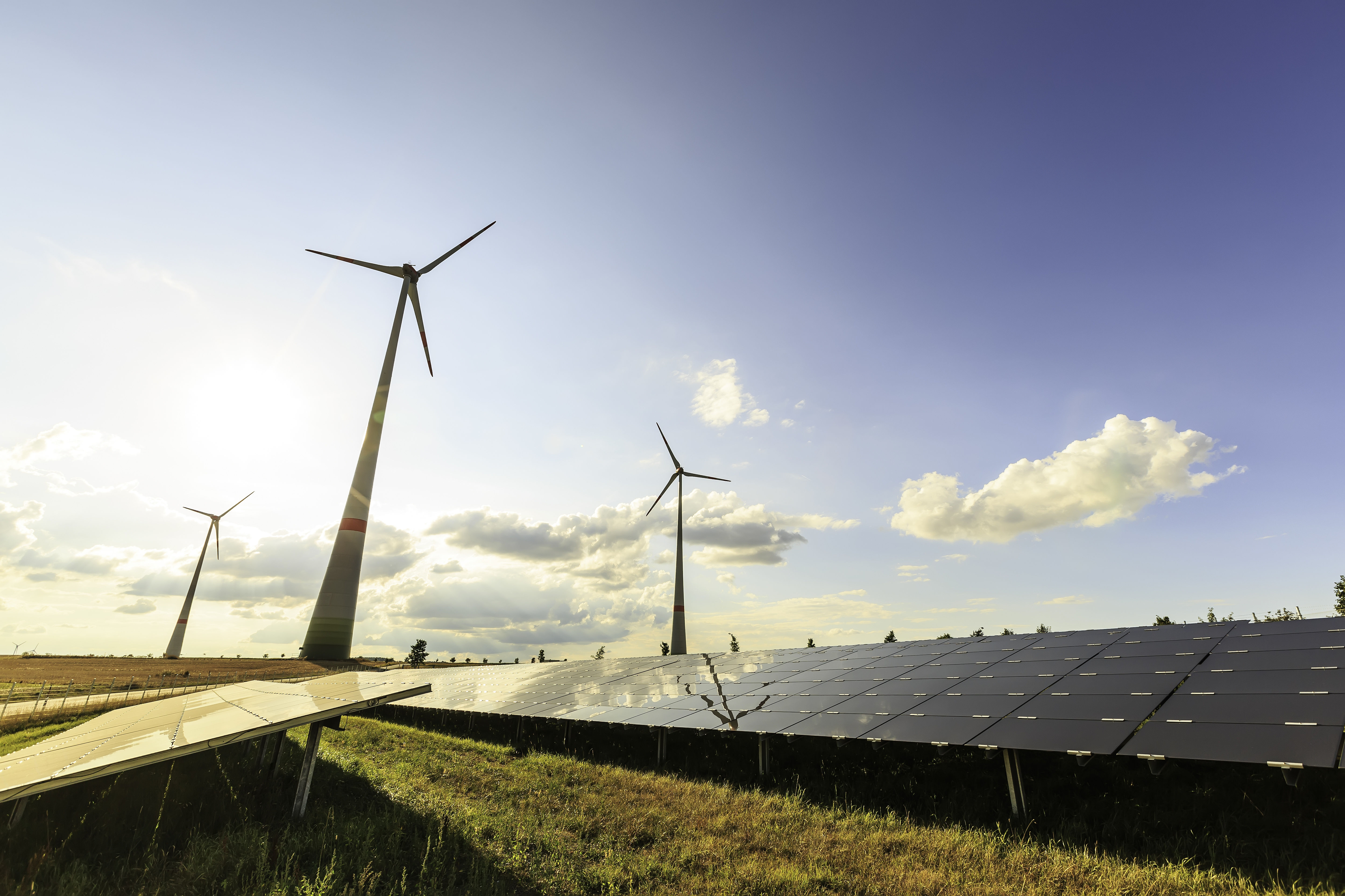 wind turbines and modern solar panels in the country side