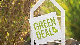 White house with natural background and label Green Deal